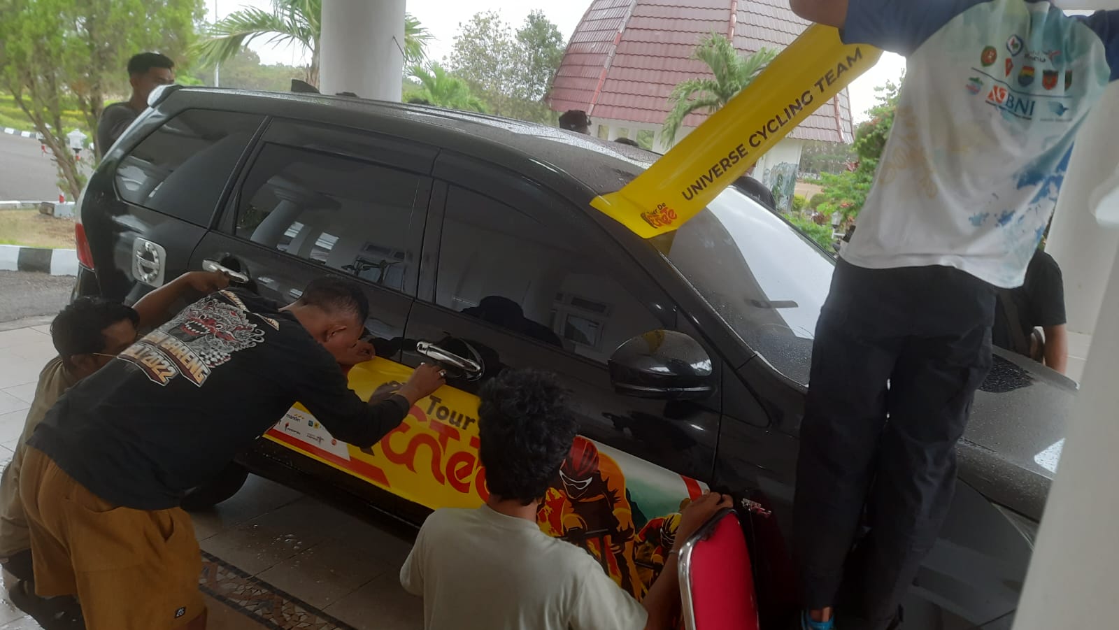 a number of committee members worked on branding by installing tour de entete 2025 stickers, sunday (07092025) in the yard of the ntt governor's official residence in kupang.